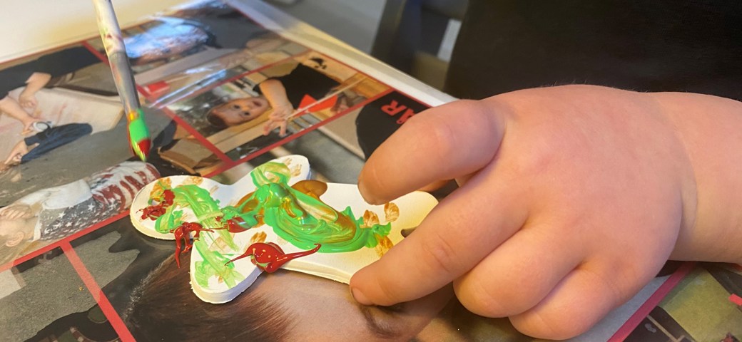 Et barn maler en figur i hånden